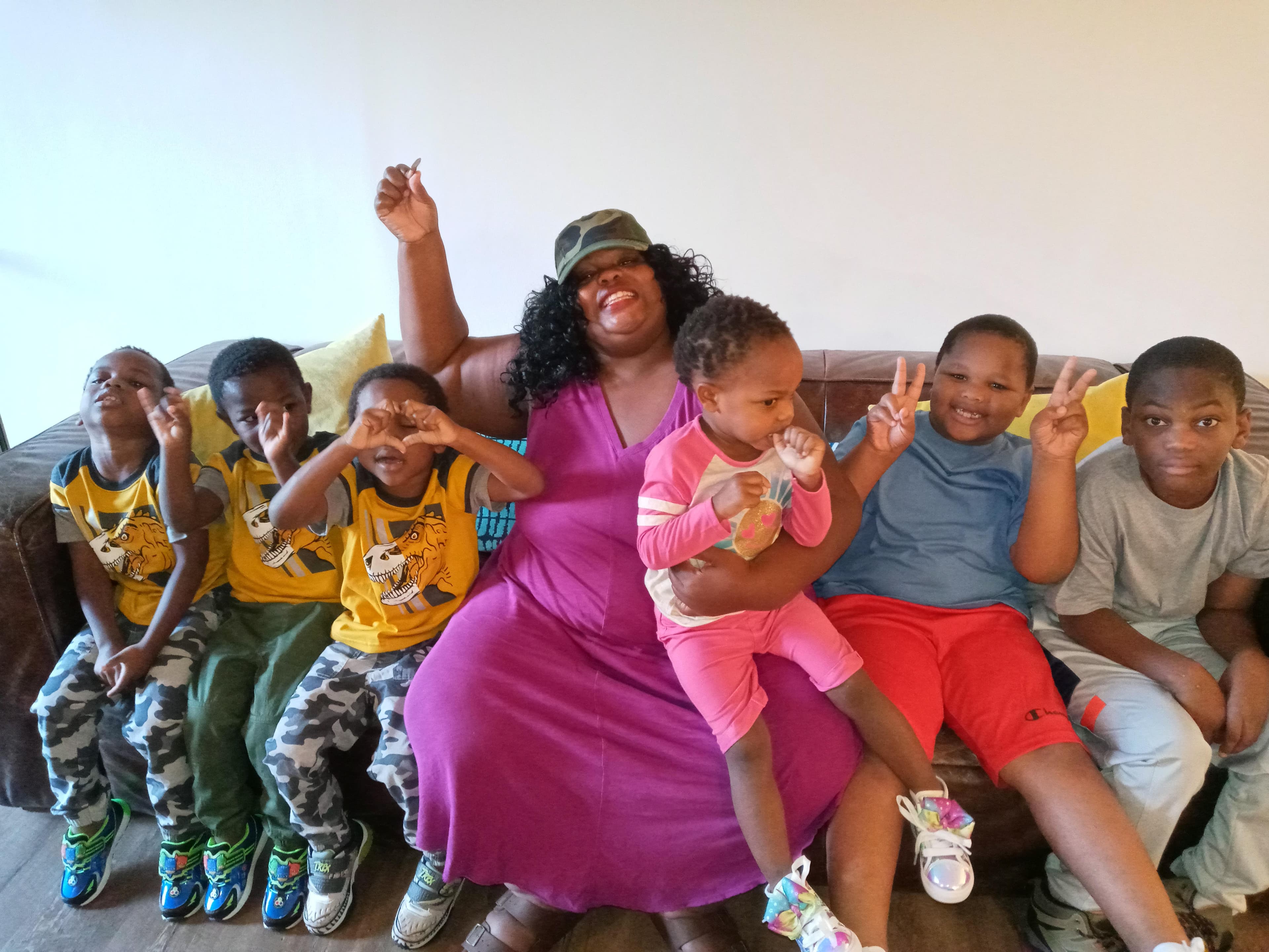 Smiling woman giving a piggyback ride to a laughing young girl.